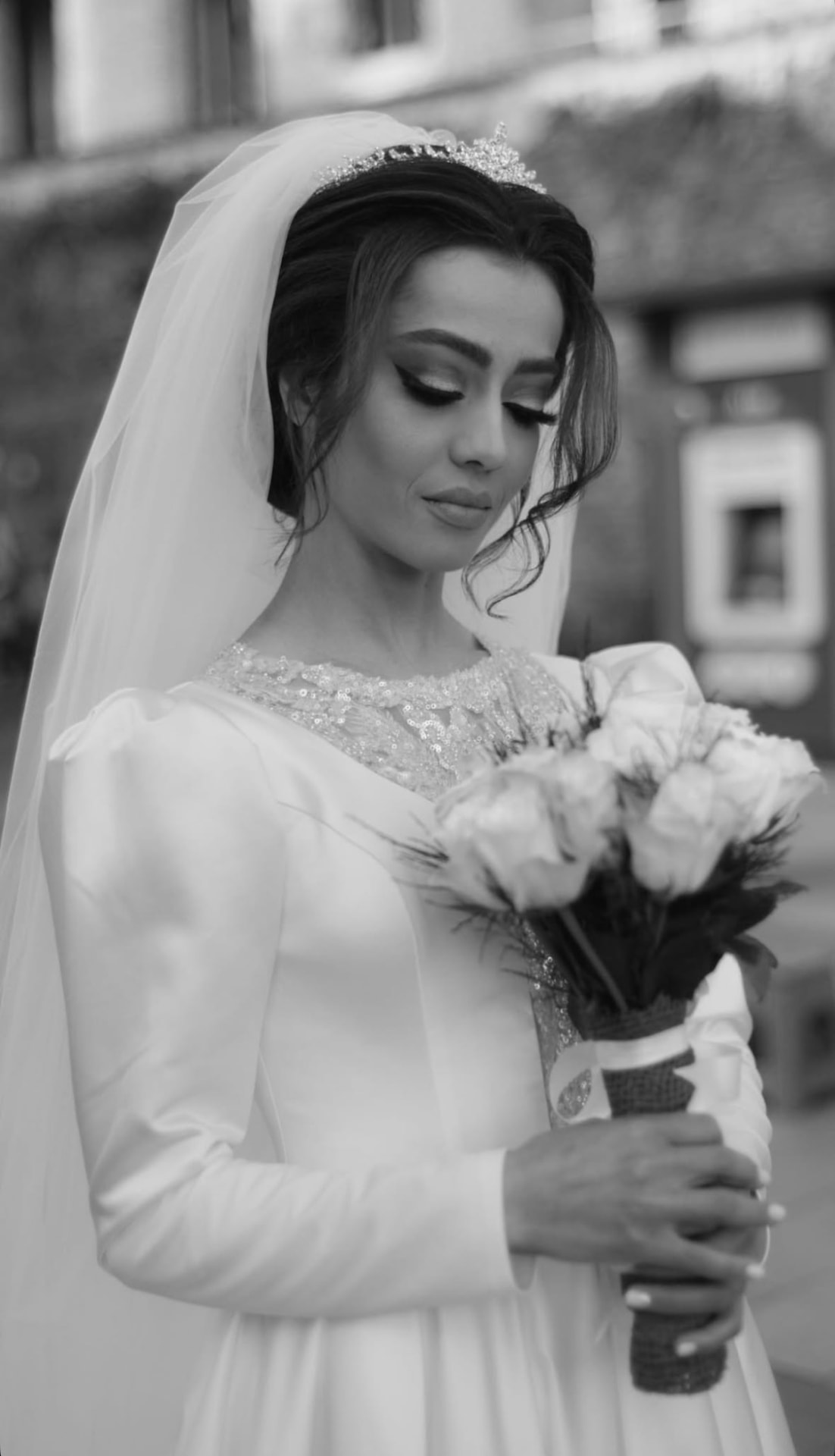 Black and white portrait of the bride wearing a tiara and veil