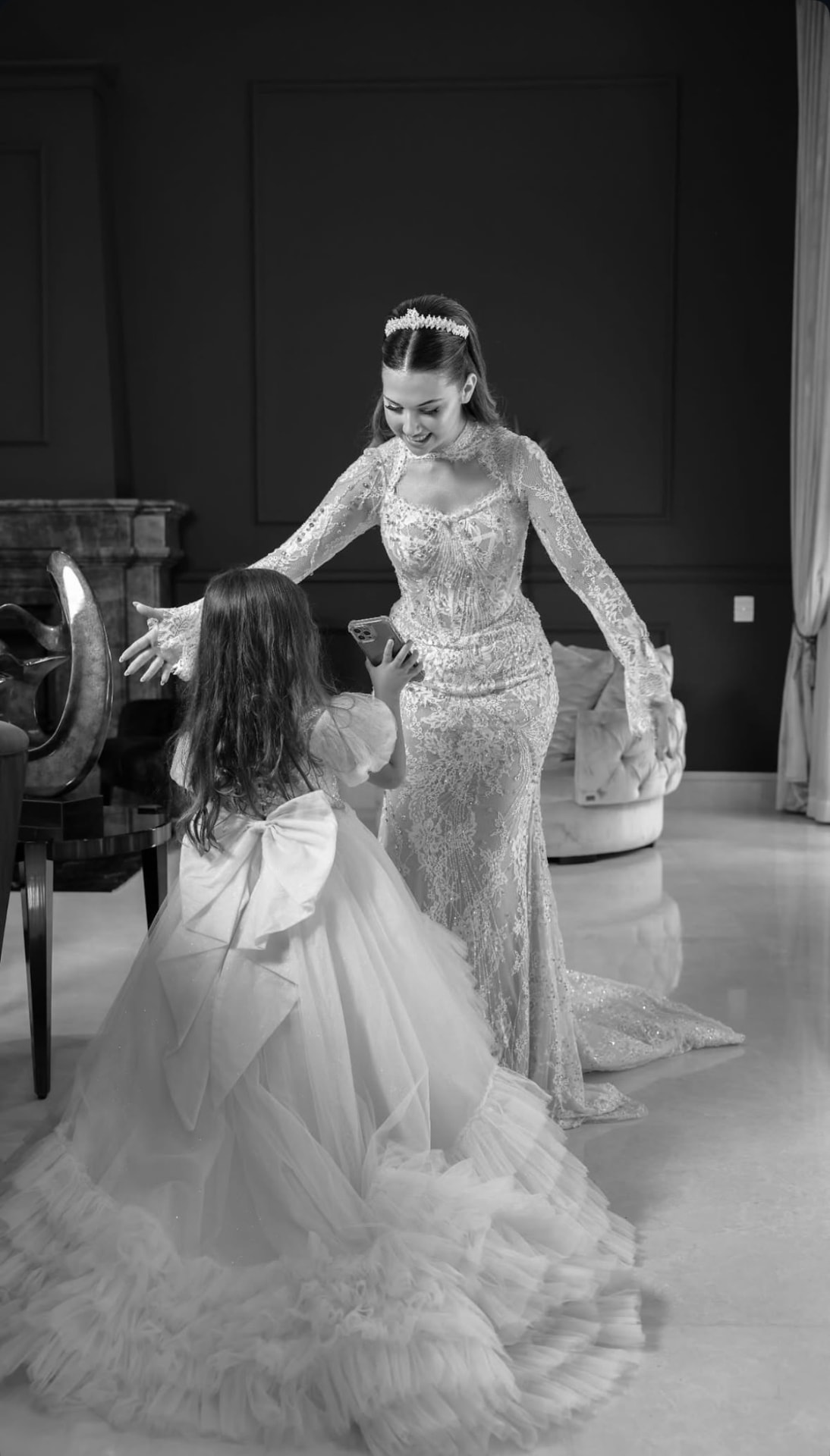 Black and white photograph of a bride with a flower girl